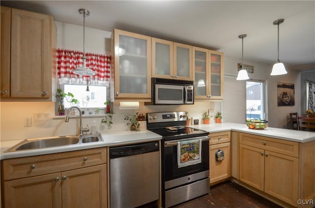 kitchen with sink, hanging light fixtures, light brown cabinetry, kitchen peninsula, and stainless steel appliances