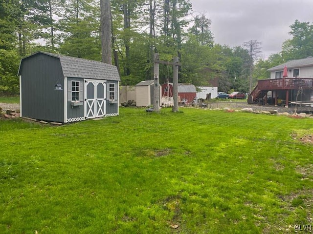 view of yard featuring an outbuilding, a shed, and stairway