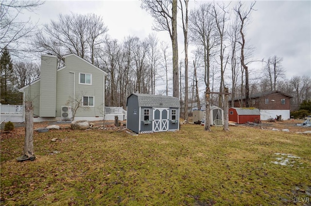 view of yard featuring a storage unit and an outdoor structure