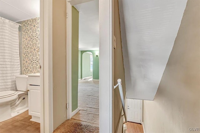 interior space with hardwood / wood-style floors and toilet