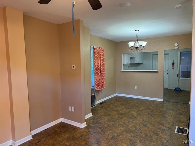 empty room featuring an inviting chandelier