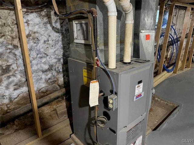 utility room featuring heating unit