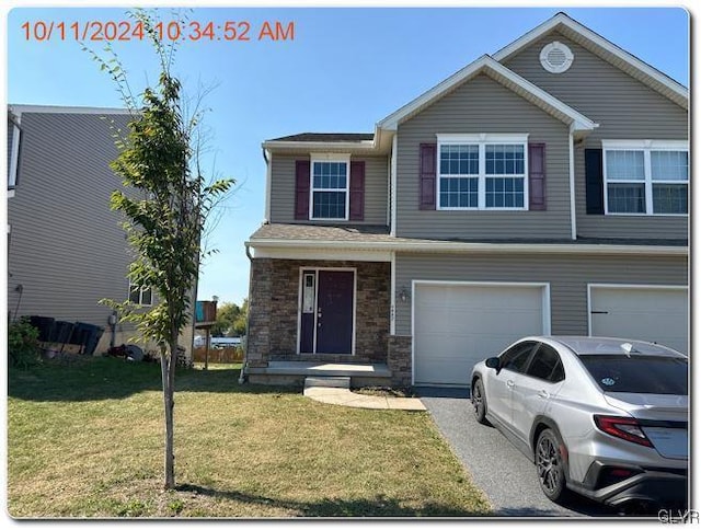 view of front facade featuring a front yard and a garage