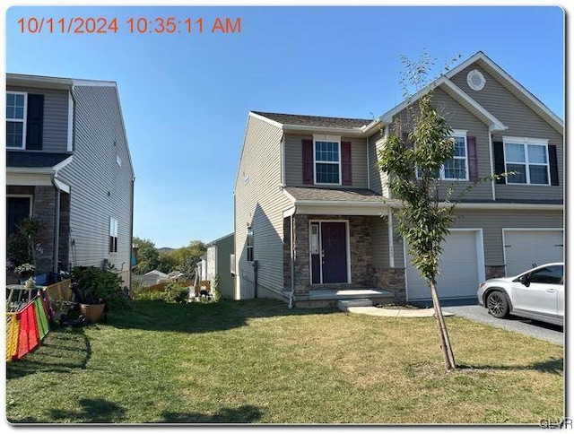 view of front of house featuring a front yard and a garage