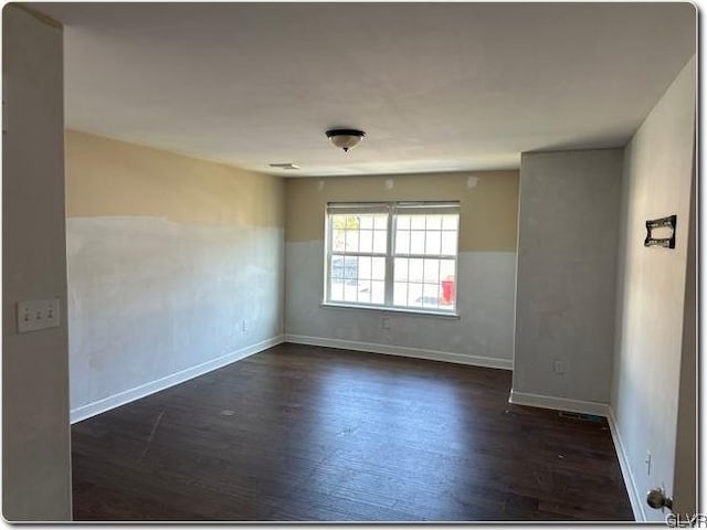 unfurnished room featuring dark hardwood / wood-style flooring