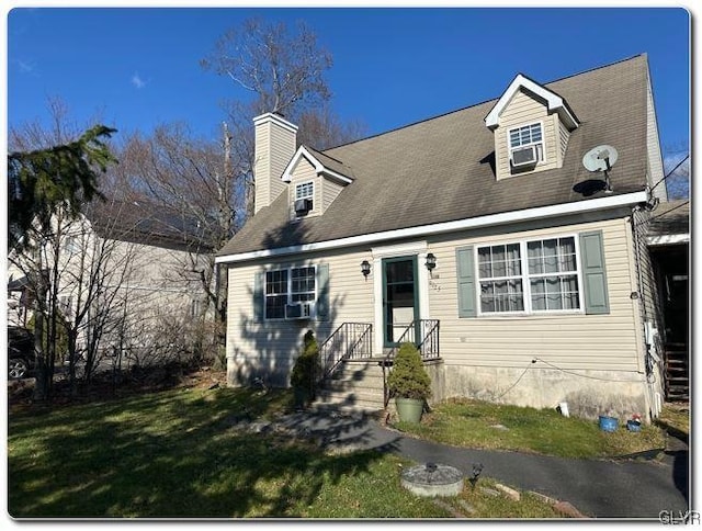 new england style home with a front lawn