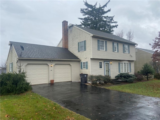 view of front of property with a garage and a front yard