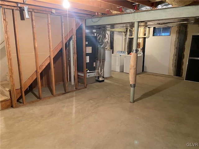 basement with heating unit, washer and clothes dryer, and gas water heater