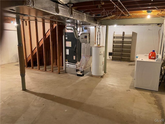 basement featuring electric water heater, heating unit, and washing machine and clothes dryer