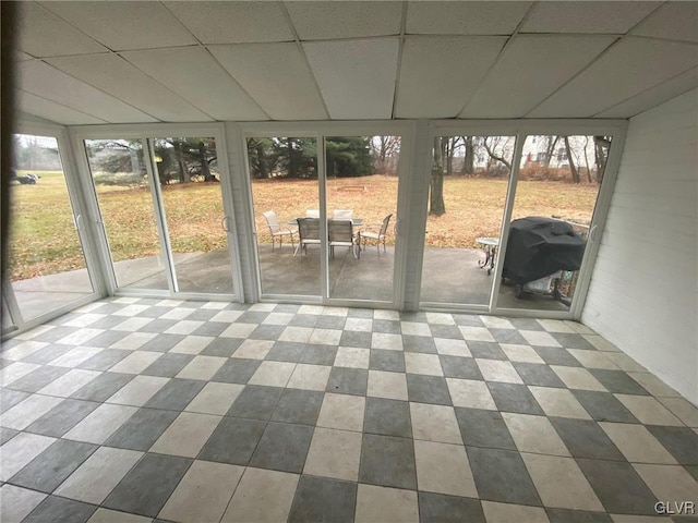 unfurnished sunroom featuring a drop ceiling