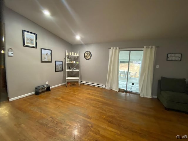 sitting room with vaulted ceiling, wood-type flooring, and a baseboard radiator