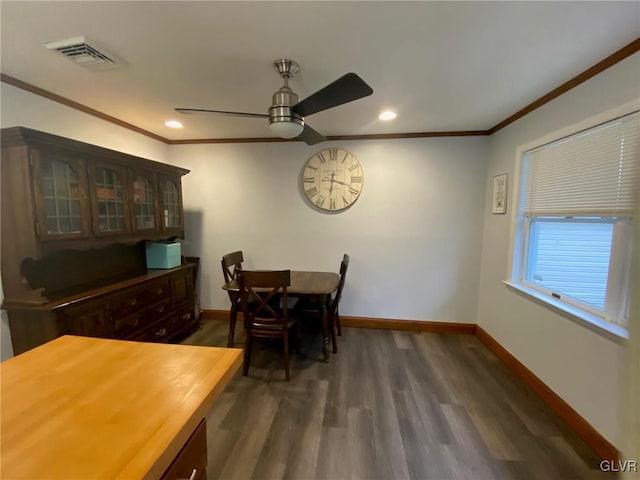 dining room with ornamental molding, ceiling fan, and dark wood-type flooring