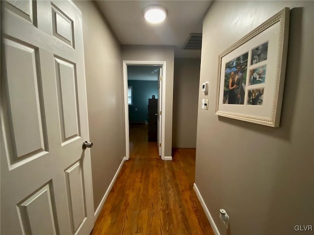 hall with dark hardwood / wood-style flooring