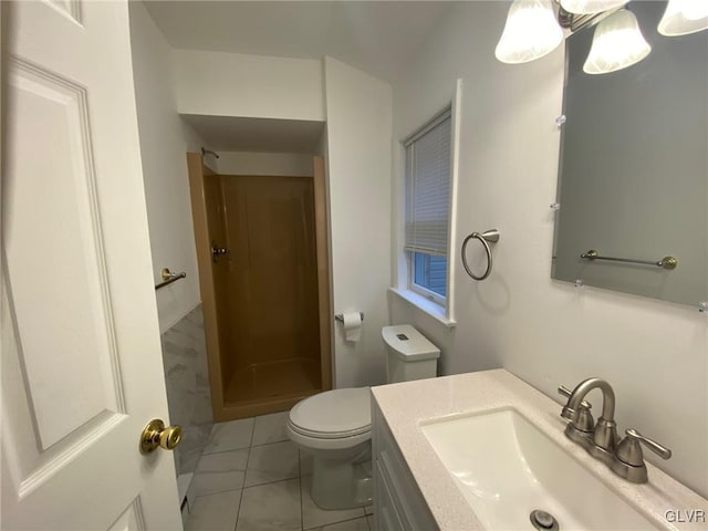 bathroom featuring a shower, tile patterned floors, vanity, and toilet