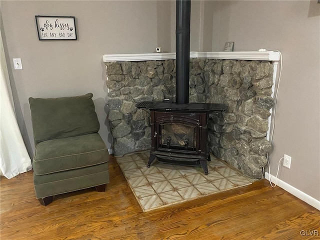 interior details with a wood stove and hardwood / wood-style floors