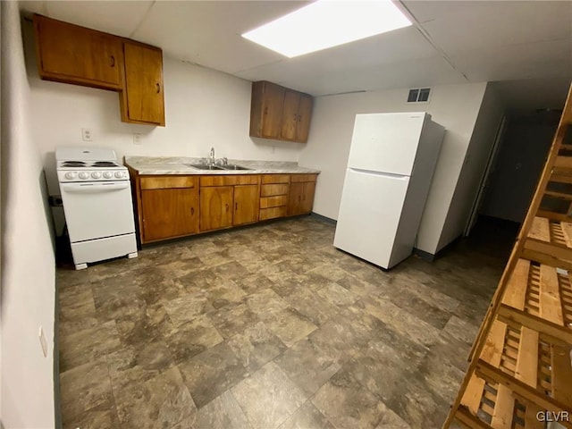 kitchen featuring white appliances and sink