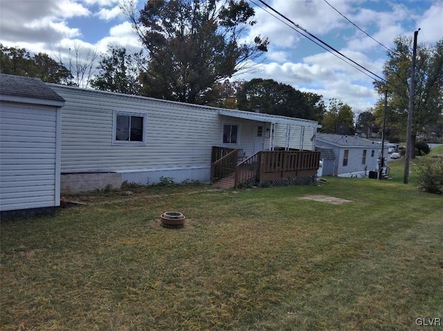 rear view of house featuring a yard