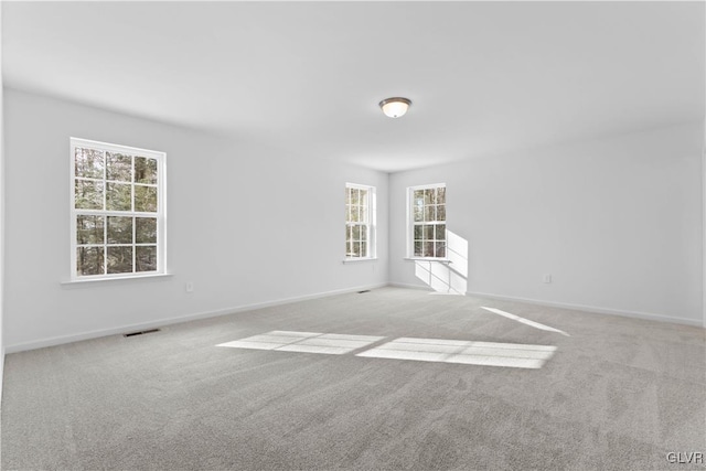 unfurnished room with light colored carpet