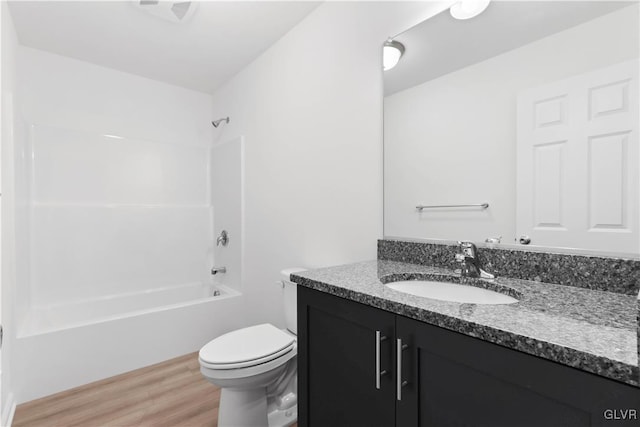 full bathroom featuring wood-type flooring, vanity, toilet, and shower / tub combination