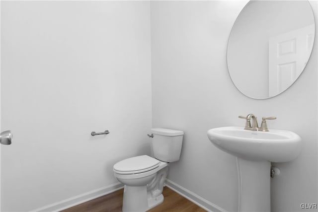 bathroom with sink, hardwood / wood-style floors, and toilet