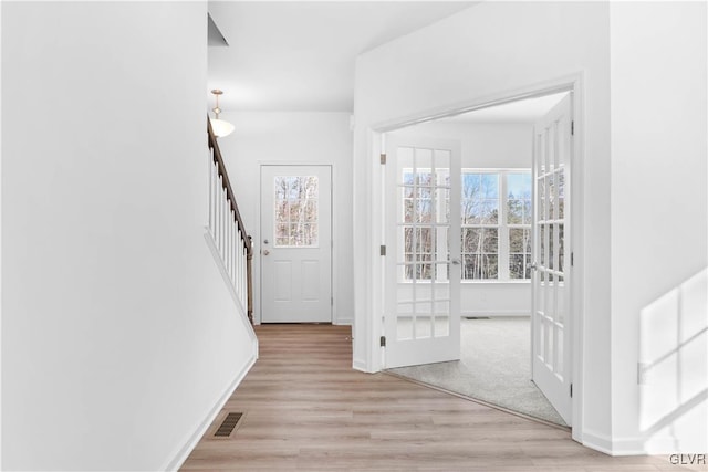 entrance foyer featuring light wood-type flooring and french doors