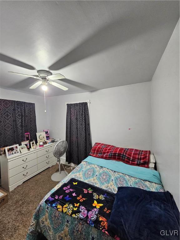 bedroom with ceiling fan and carpet floors