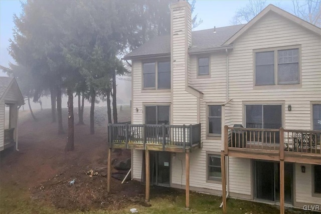 back of house featuring a wooden deck