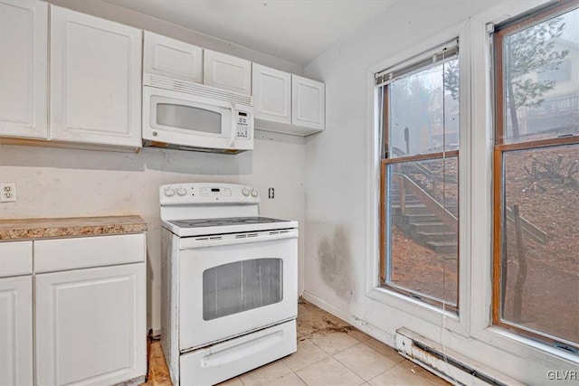 kitchen featuring light tile patterned floors, white appliances, a baseboard radiator, and white cabinetry