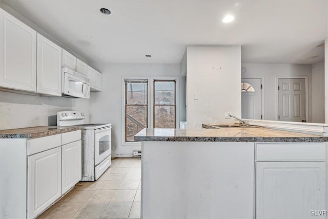 kitchen with white cabinets, light tile patterned flooring, white appliances, and sink