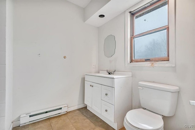 bathroom with baseboard heating, tile patterned flooring, vanity, and toilet