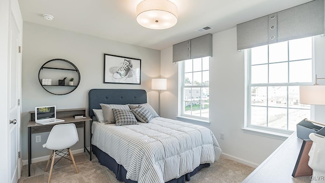 bedroom featuring light carpet