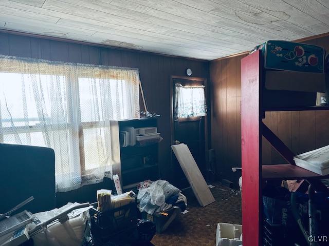 bedroom with wooden walls