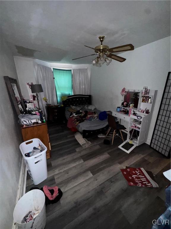 bedroom featuring ceiling fan and dark hardwood / wood-style flooring