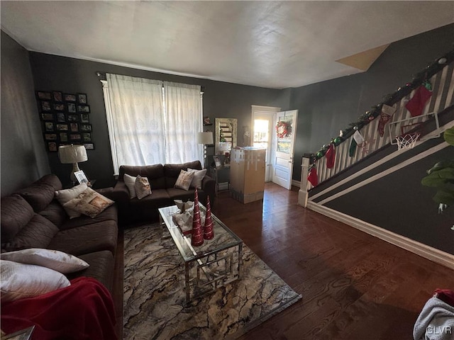 living room with dark hardwood / wood-style floors and a healthy amount of sunlight