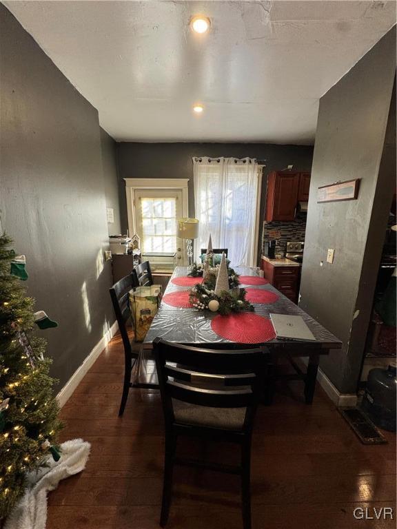 dining room with dark wood-type flooring