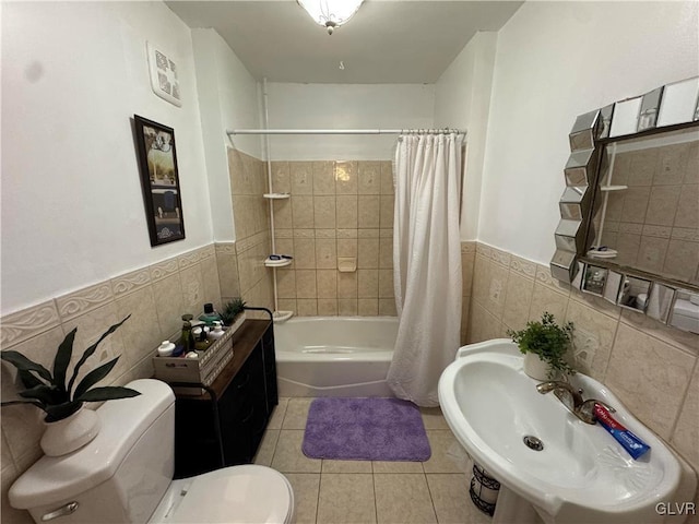 full bathroom with shower / bath combination with curtain, sink, tile walls, tile patterned flooring, and toilet