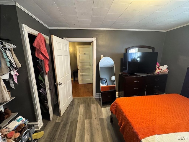 bedroom with ornamental molding and hardwood / wood-style flooring