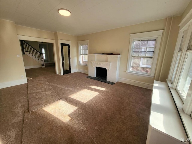 unfurnished living room featuring dark colored carpet