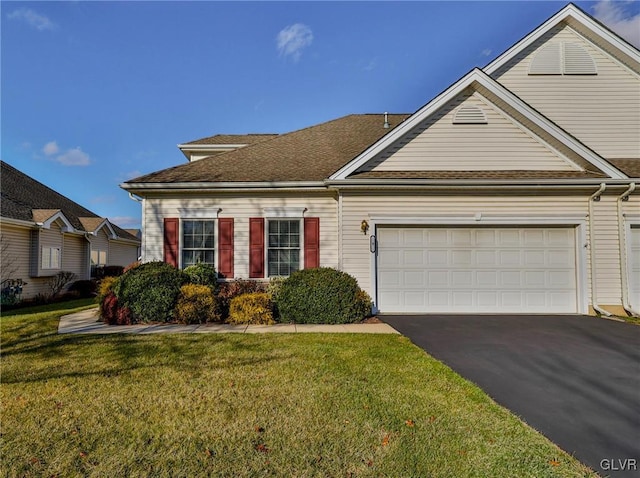 view of front of home with a front lawn and a garage