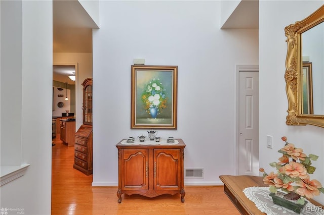 hallway with light hardwood / wood-style floors