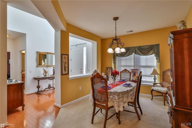 dining space featuring a chandelier and light hardwood / wood-style floors