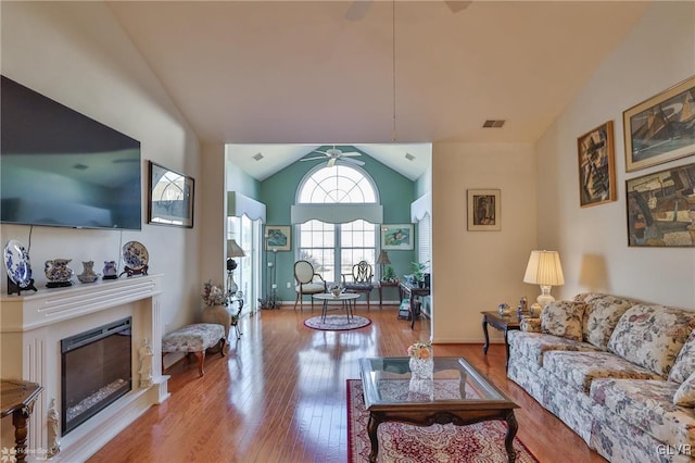 living room featuring light hardwood / wood-style flooring and lofted ceiling