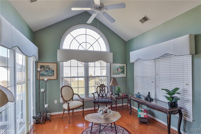 sitting room featuring ceiling fan, light hardwood / wood-style floors, and lofted ceiling