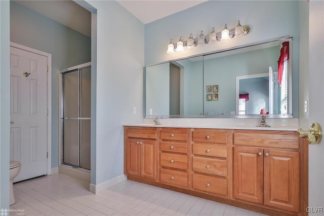 bathroom with tile patterned floors, a shower with door, and vanity