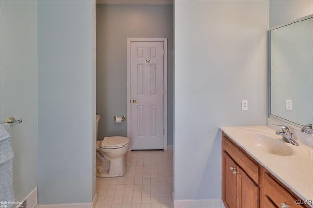 bathroom featuring tile patterned floors, vanity, and toilet