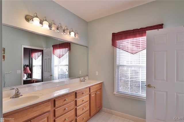 bathroom with tile patterned floors and vanity