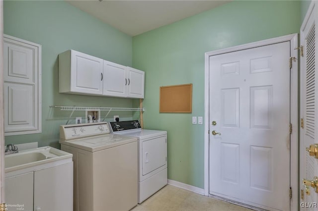 laundry area featuring cabinets, sink, and washing machine and clothes dryer