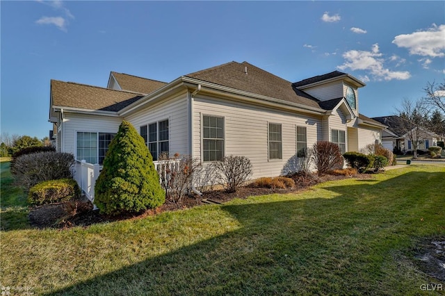 view of property exterior featuring a yard