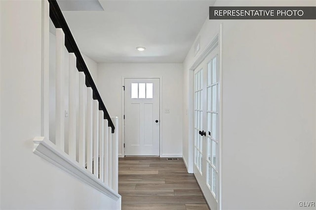 foyer featuring french doors and light hardwood / wood-style flooring