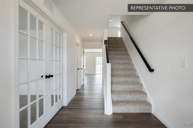 stairway with hardwood / wood-style flooring